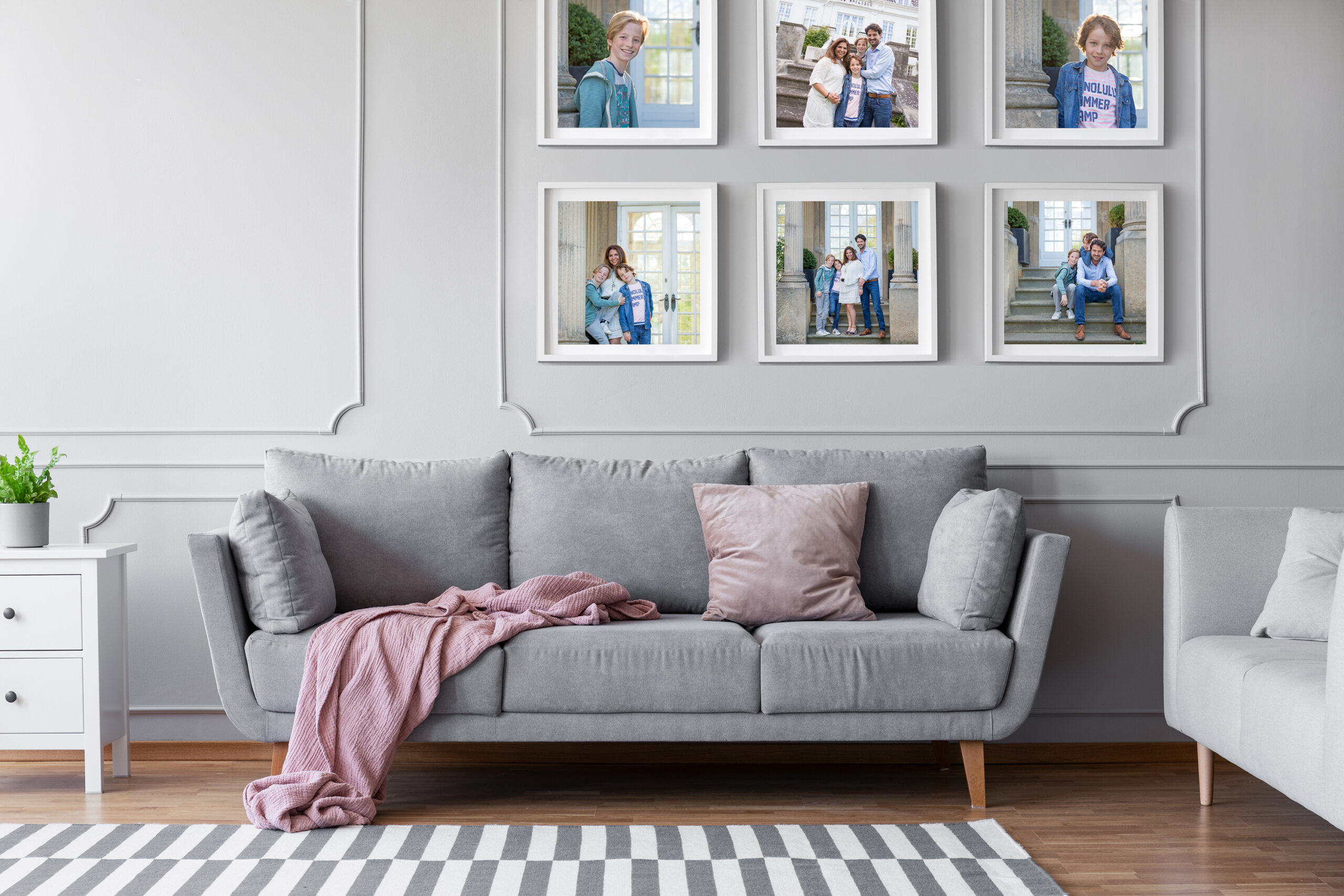 Wall Portraits by Heather Davidson Portrait Photography A set of striking wall portraits depicting a family of four having fun together hung over a grey couch in a modern living room